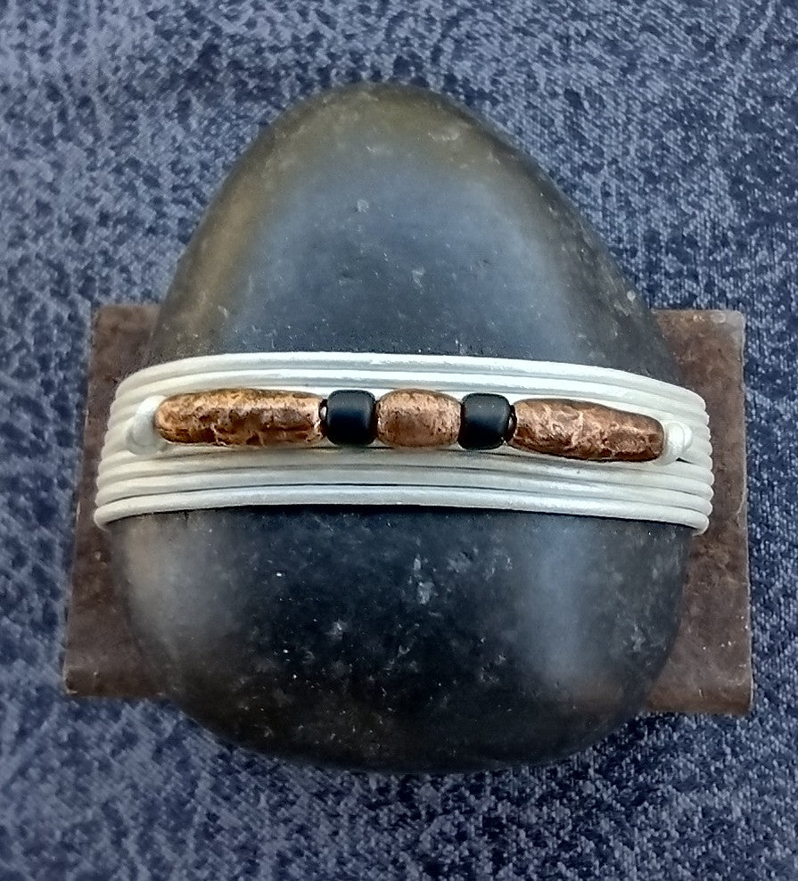 Black/White/black and copper beads Wrapped Stone