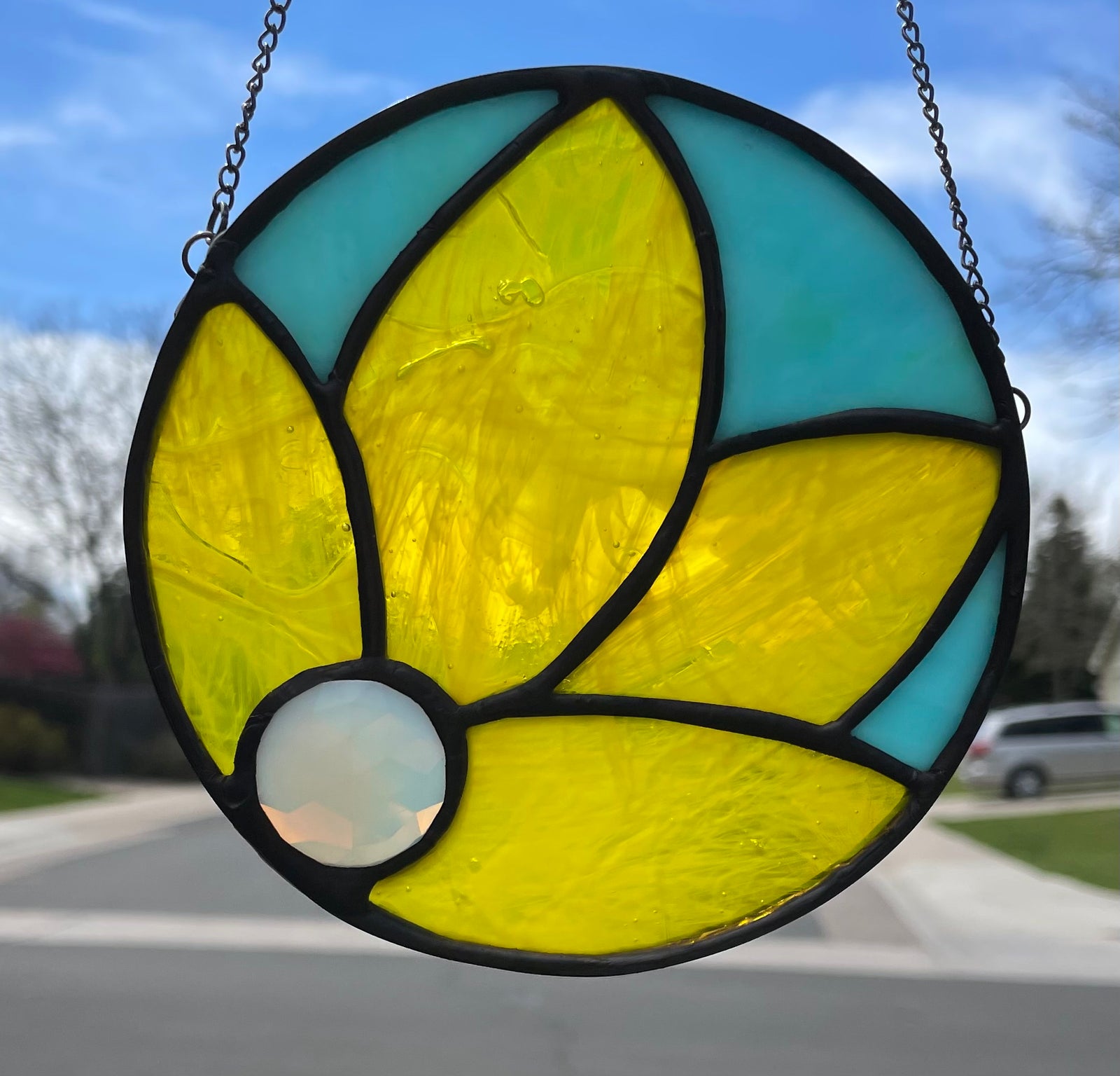 Bright yellow flower with a teal background