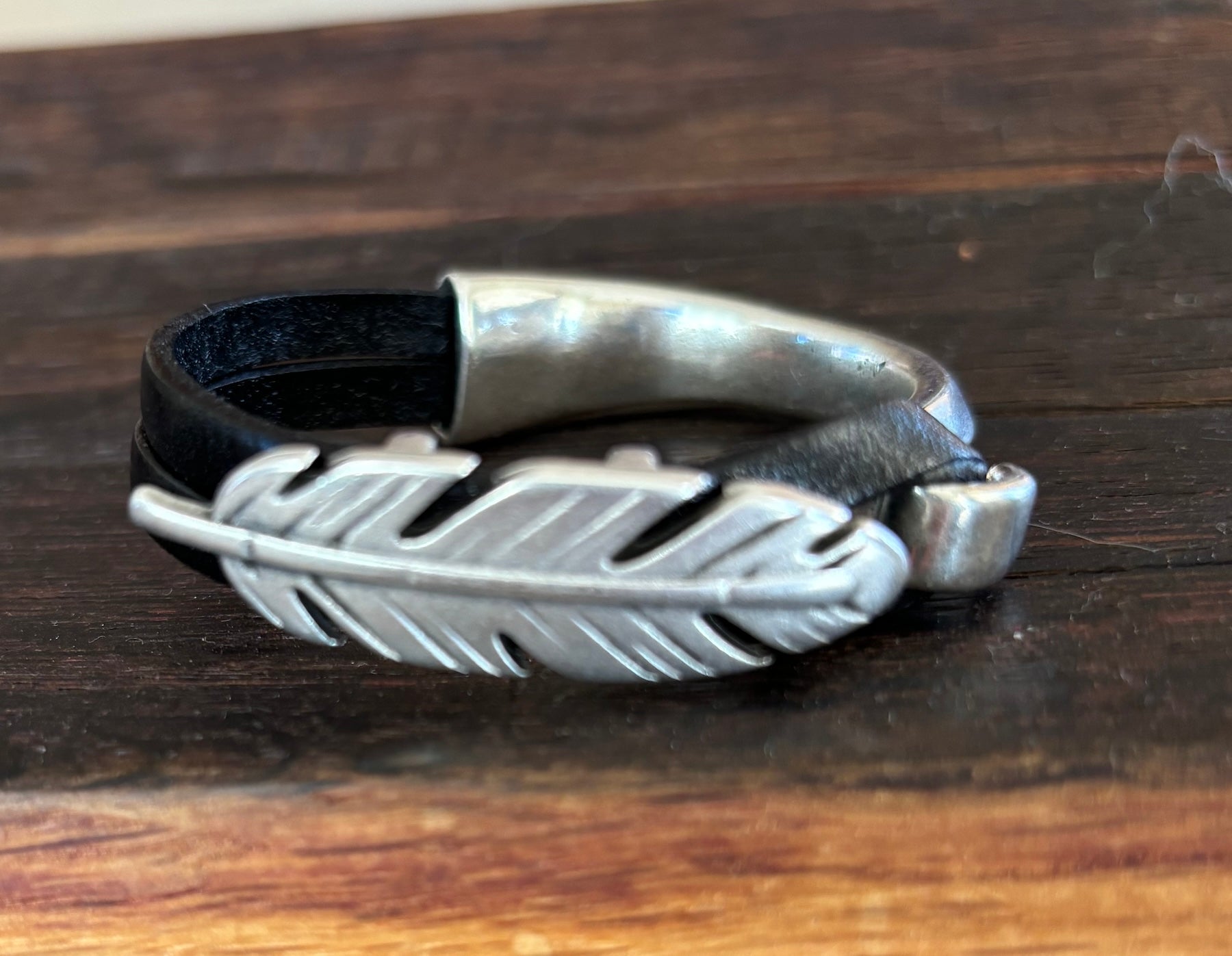 Cuff with Feather on Black leather size 5 1/2