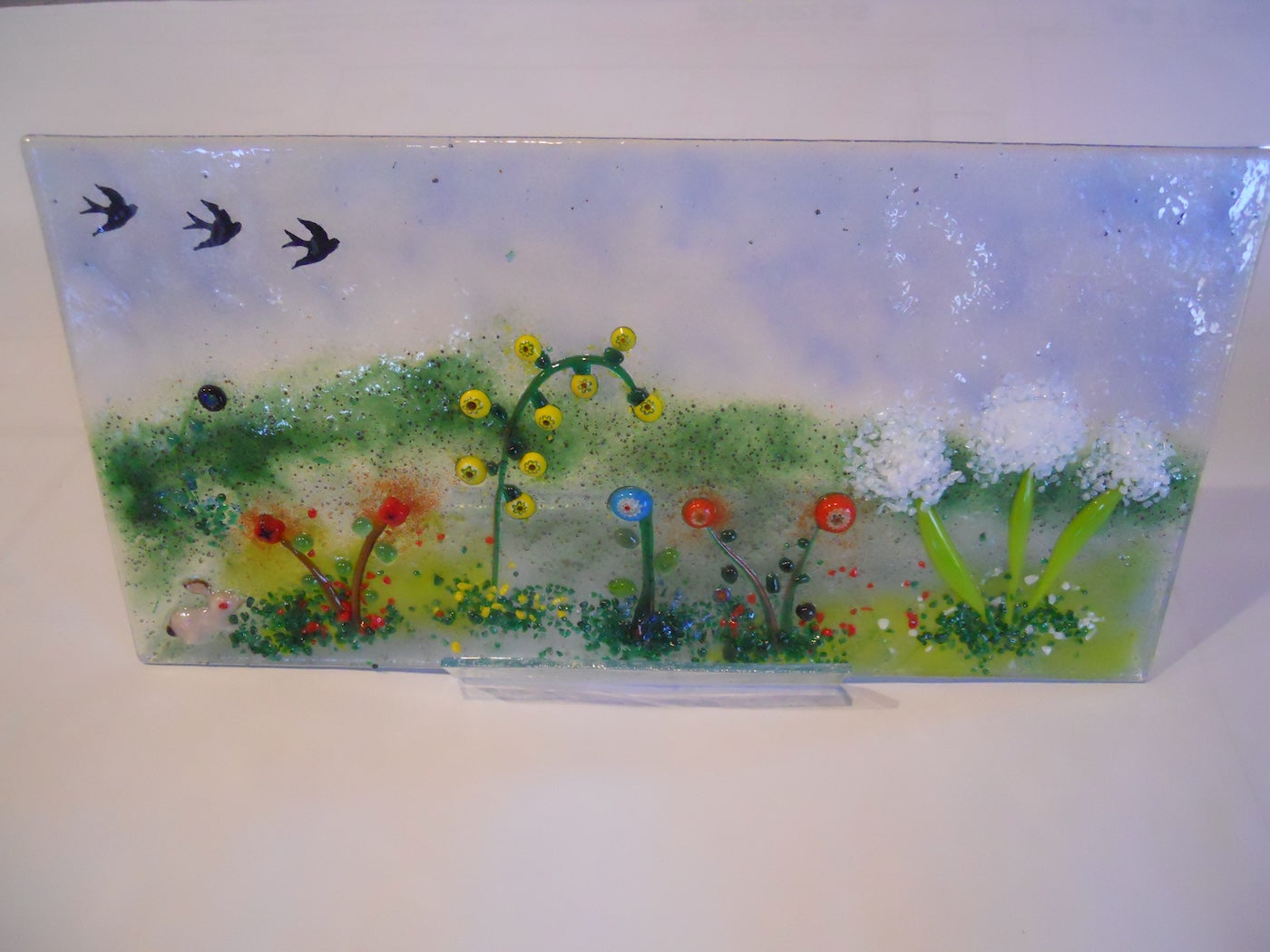Glass Flowering meadow with birds and a bunny