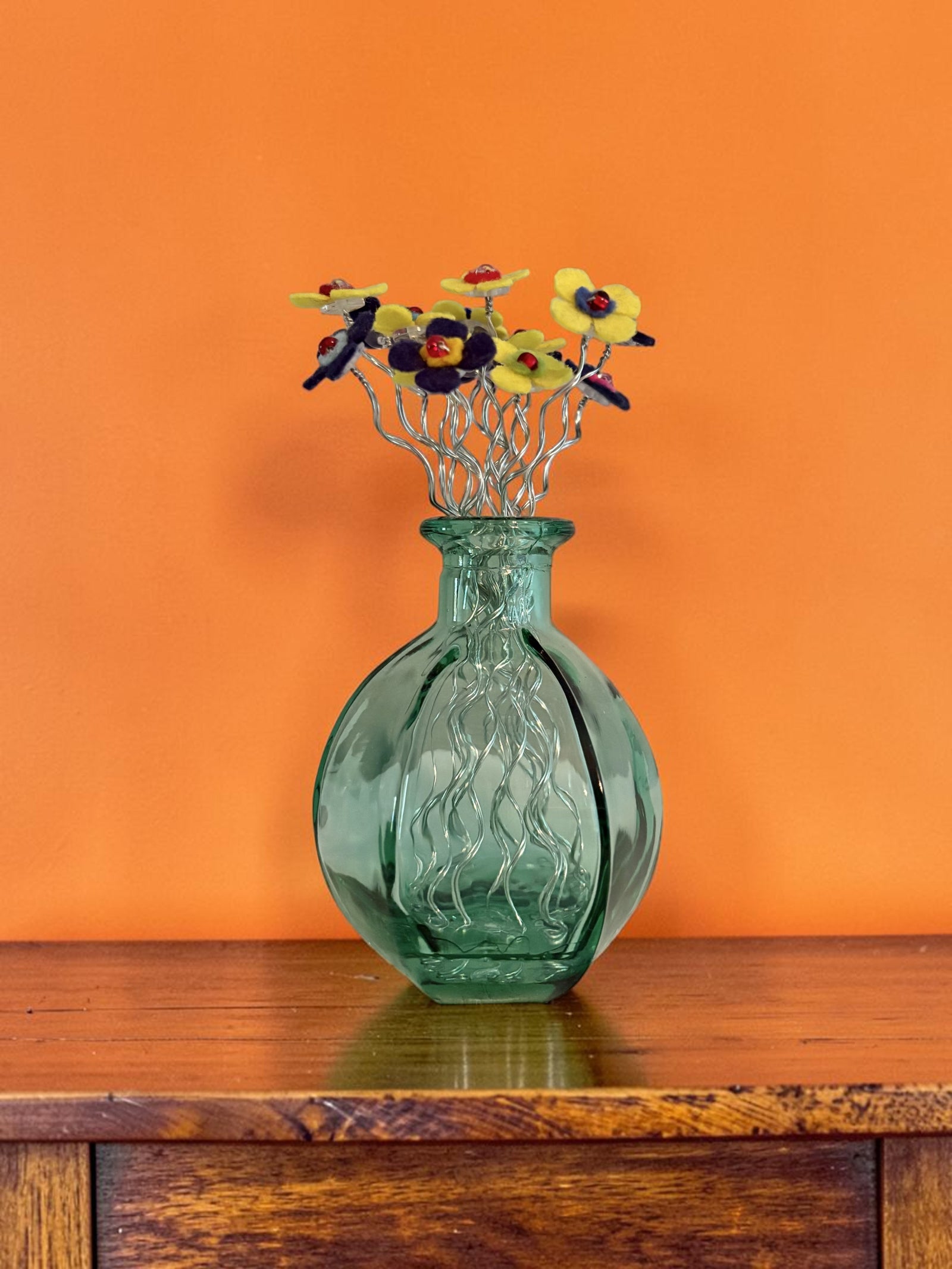 Green Vase with Blue and Yellow Flowers