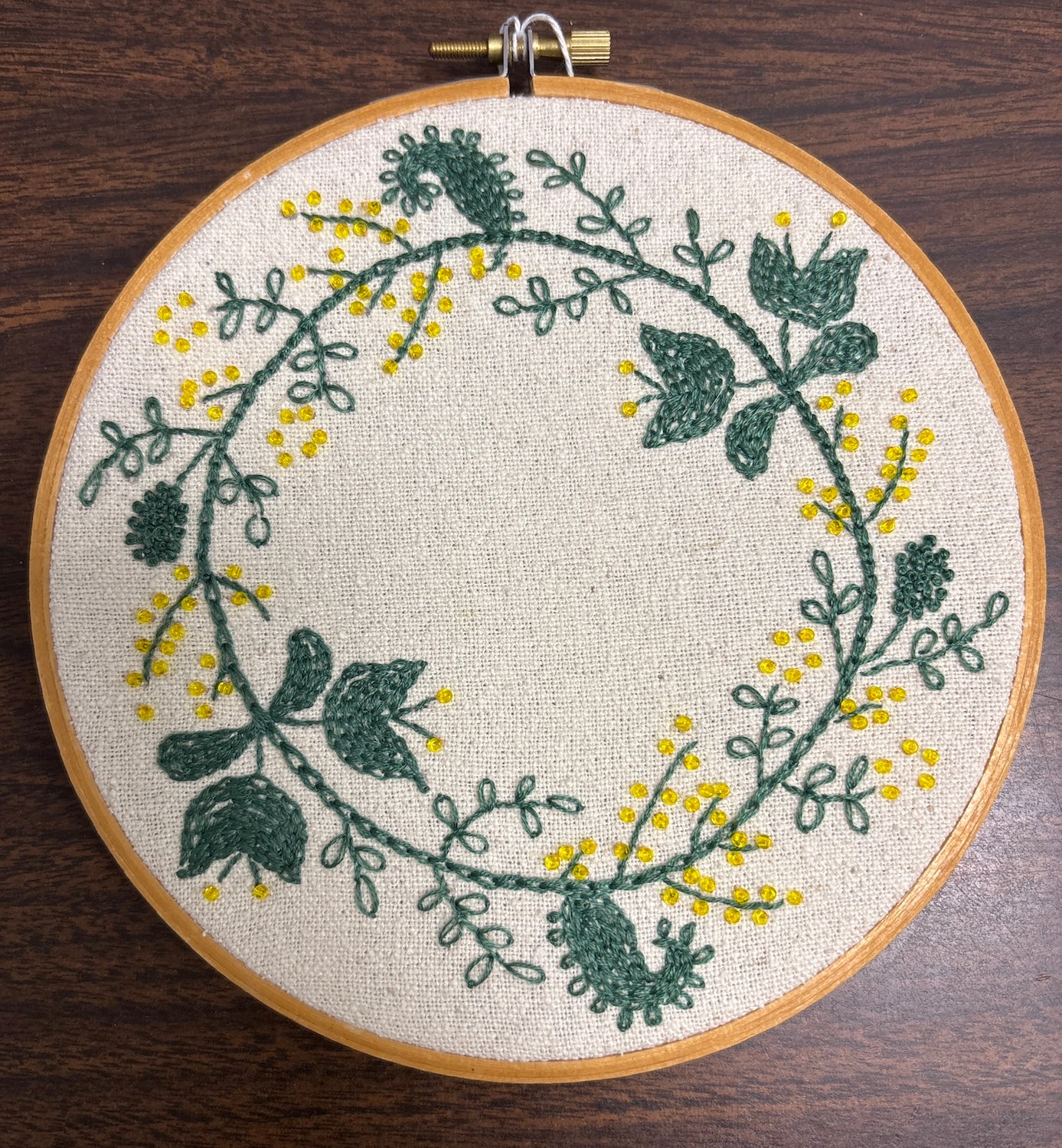 Embroidered and beaded wreath on linen