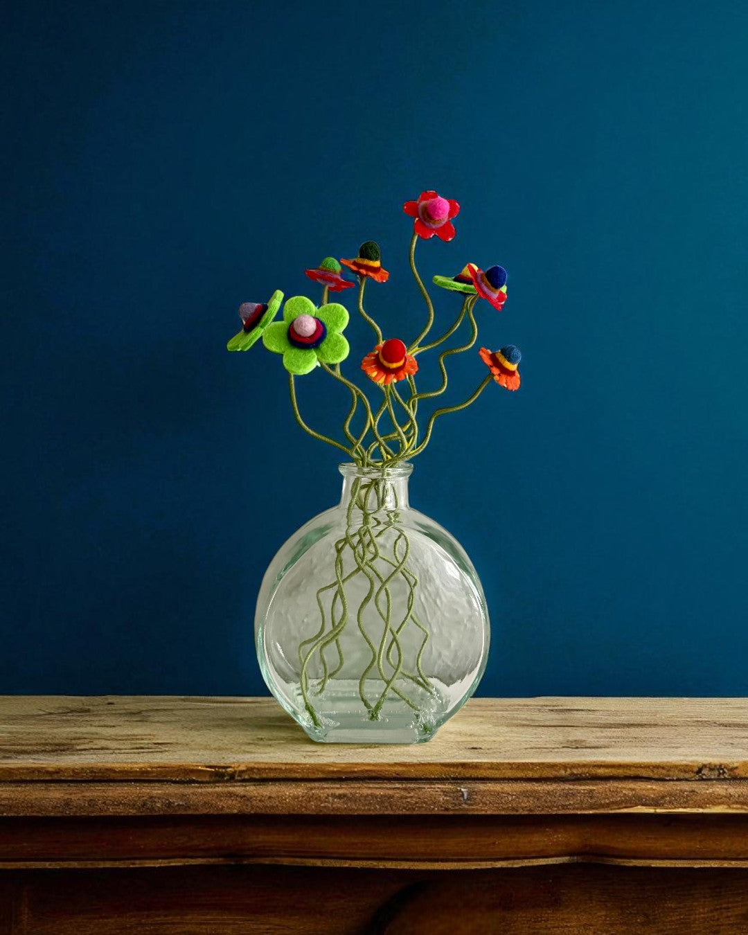 Vase with Red Orange and Green Flowers on Green Stems