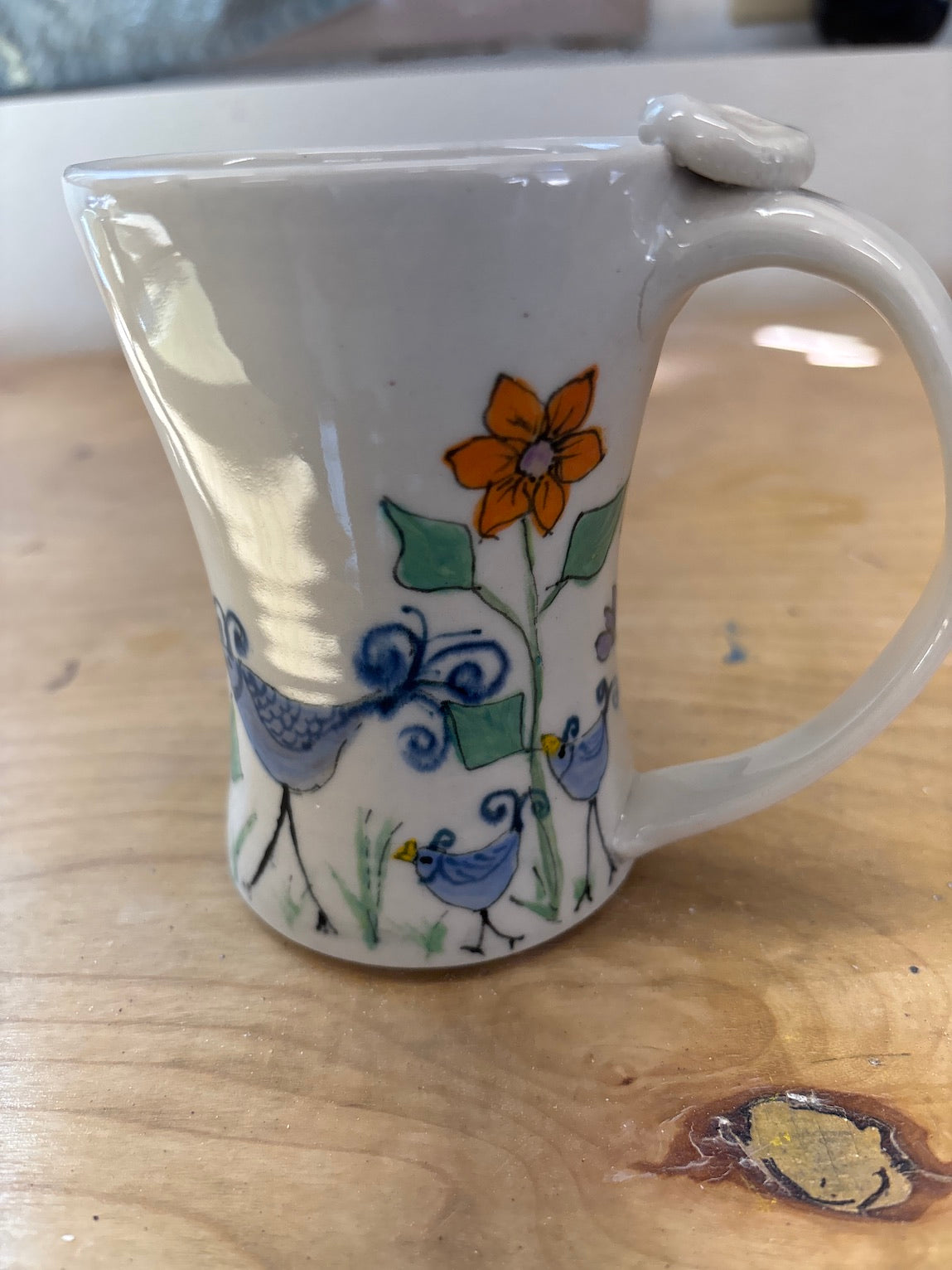 Birds in garden mug